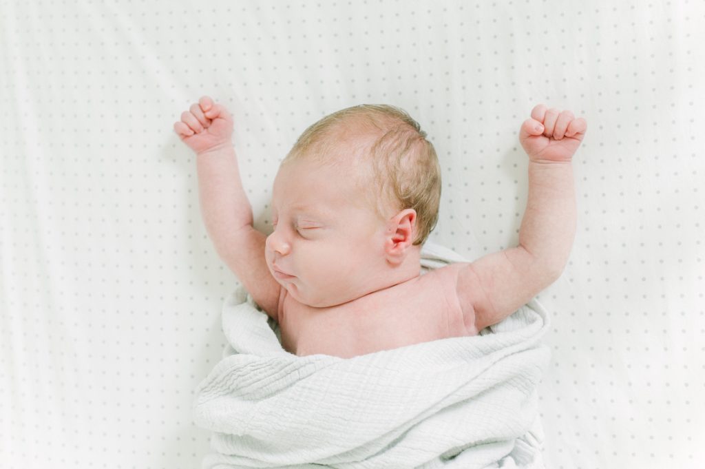 baby in crib during newborn session