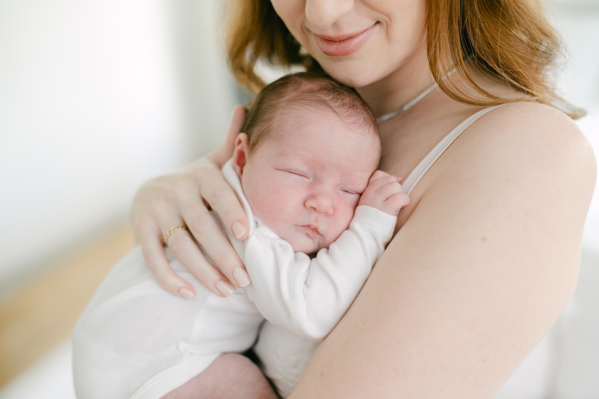 Baby snuggled on Mom's chest during a newborn session