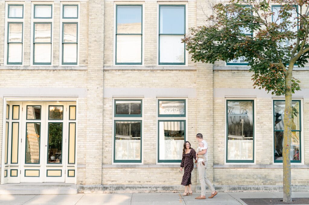 Family of three walking down the main streets of Cedarburg 