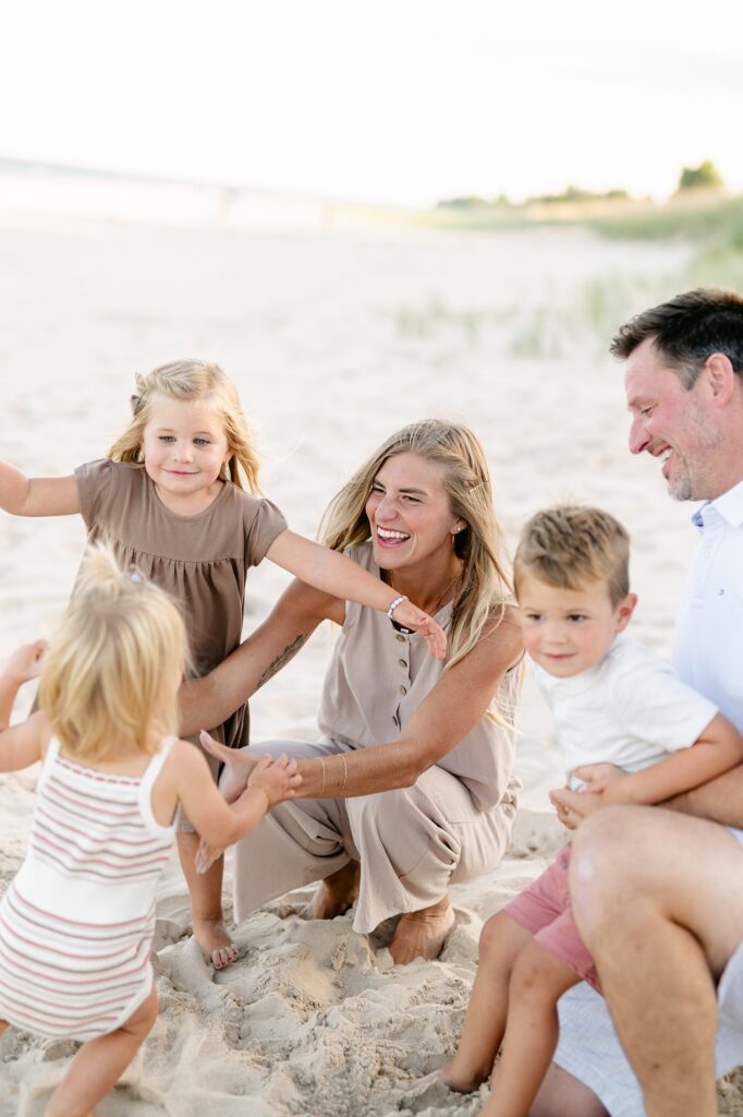 kids running into their mom's arms at the beach in Milwaukee, Wisconsin
