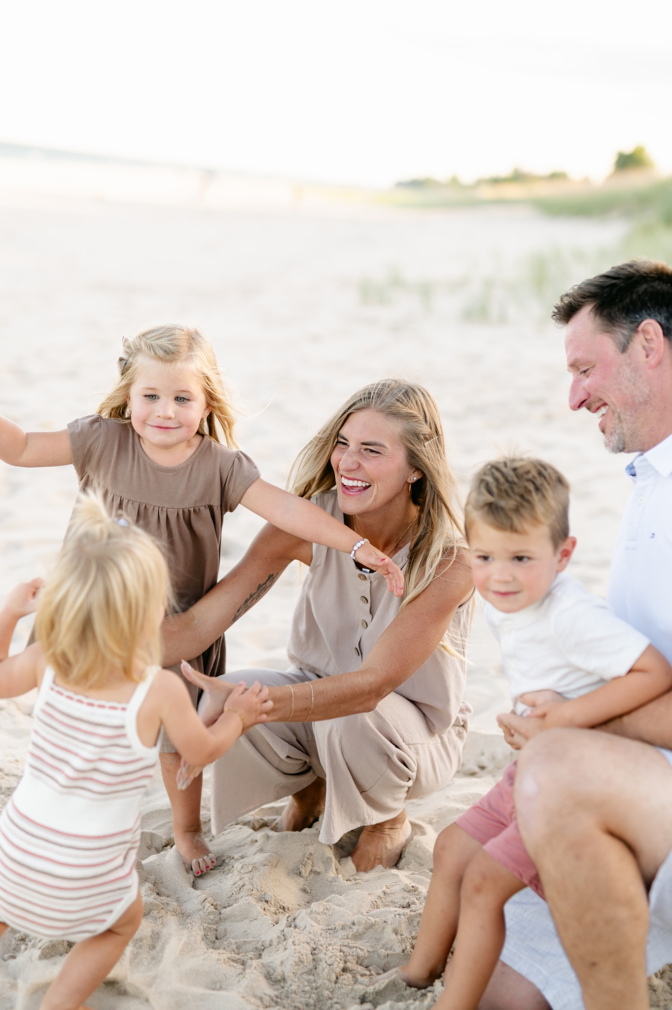 kids running into their mom's arms at the beach in Milwaukee, Wisconsin